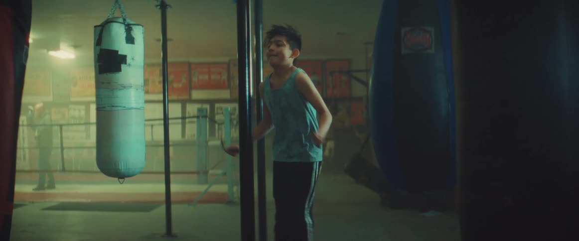Young boy jumping rope inside a gymnasium