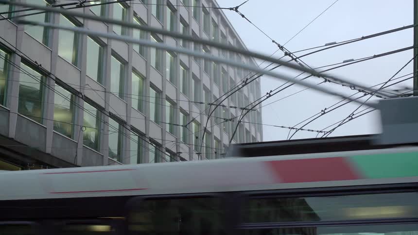 A cable car guidance system as seen from below near a large building