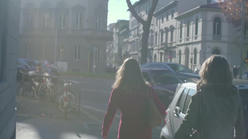 Two women walk down the road