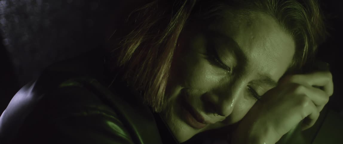 A young white woman is crying and looks very sad