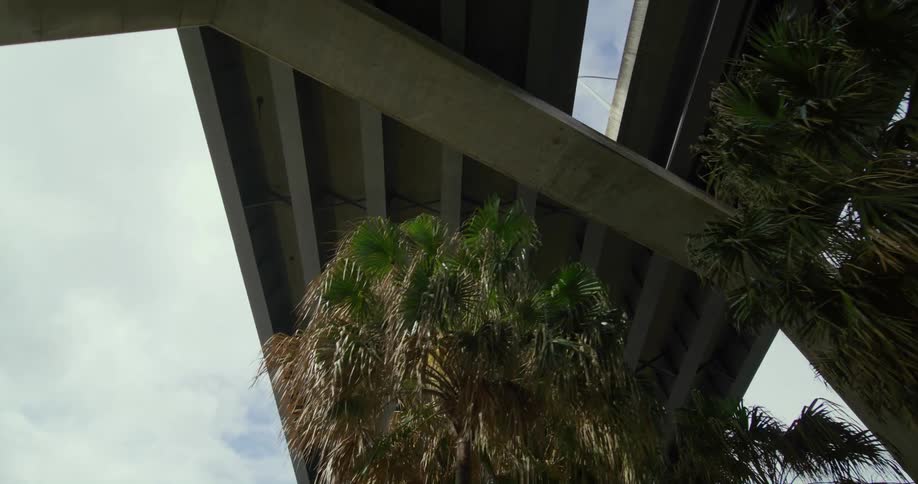 The underside of a bridge in a city during the day