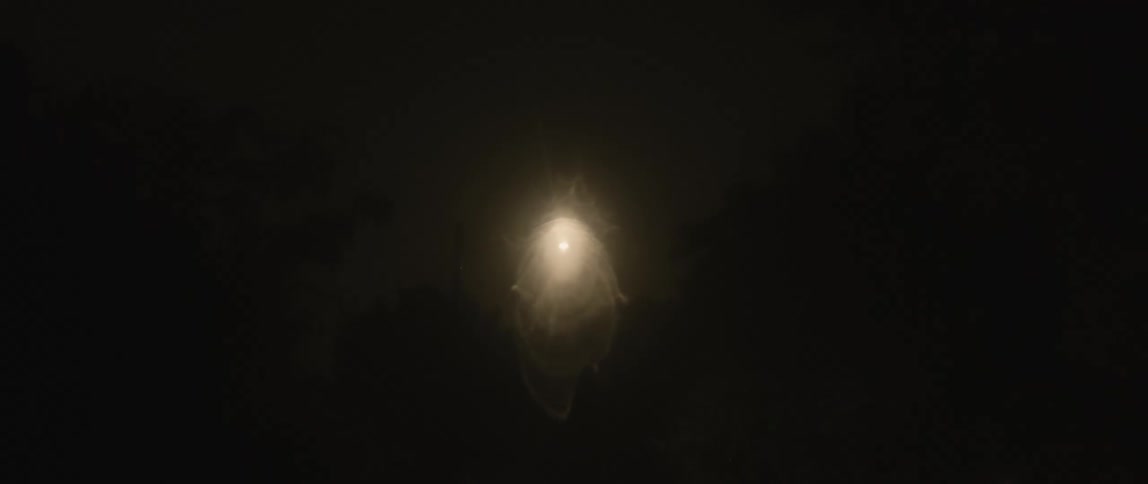 White light orb transforms on dark background