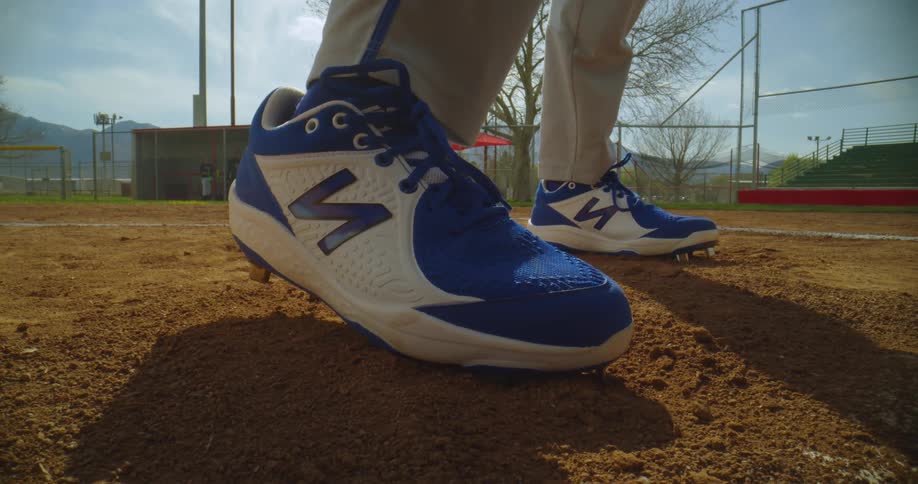 Baseball player planting his foot firmly in the ground on the field at morning