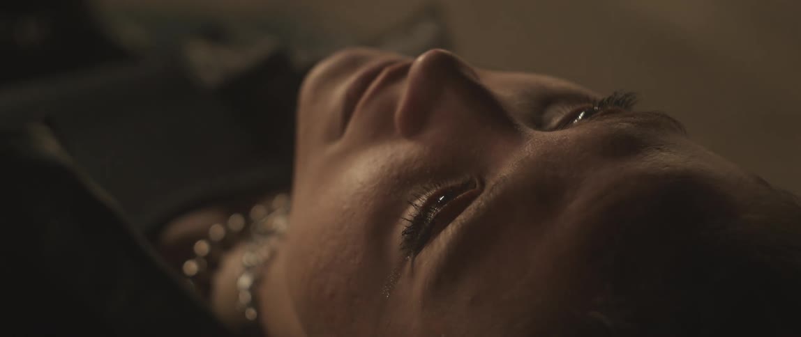 Woman lying down looks up and blinks her eyelashes