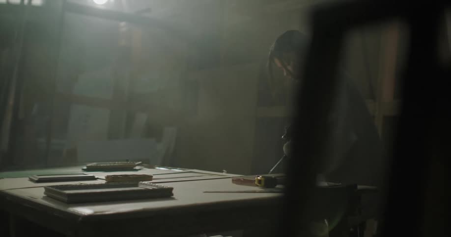Woman chiselling timber in workshop