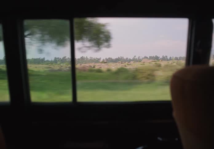 A man taps nervously on the steering wheel as he drives