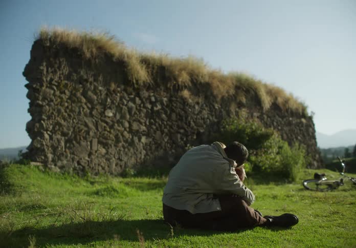 Father and daughter play behind shielding wall before father looks around surprised and holds girl protectively close