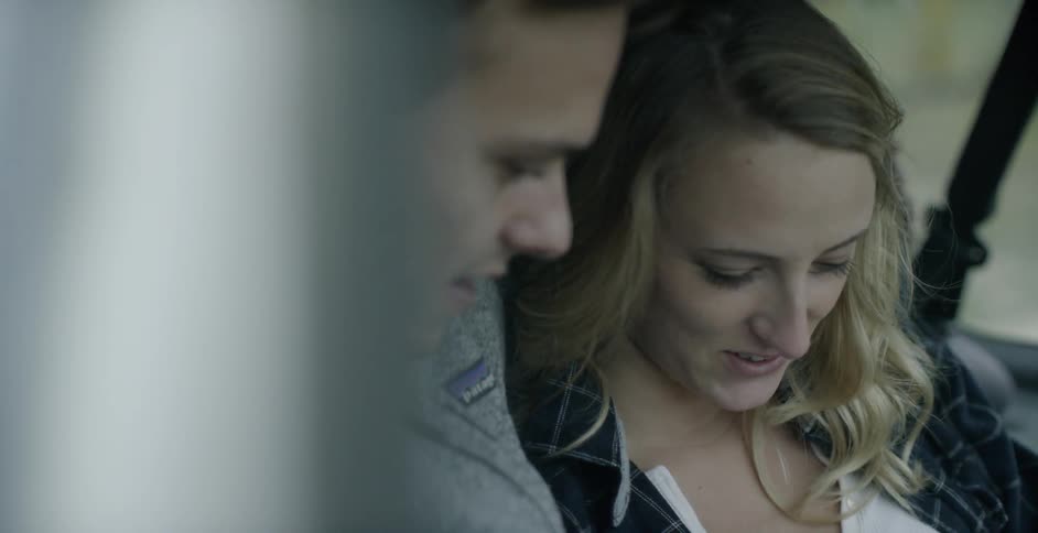 A young couple laughing in a car