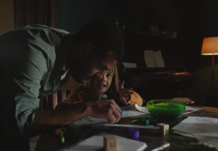 Father and daughter are hanging out together inside of this house