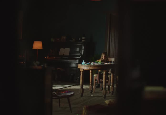 Girl sits at round table playing