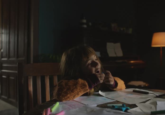 A girl is coloring at the table