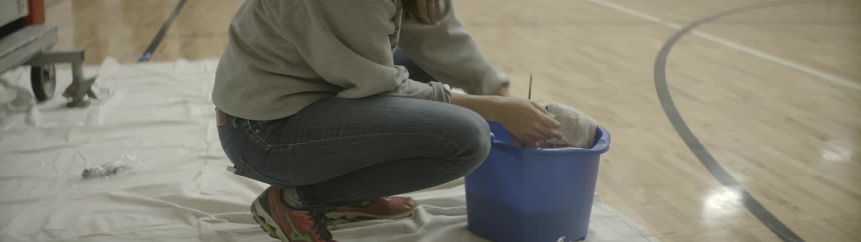 An artist cleans her supplies