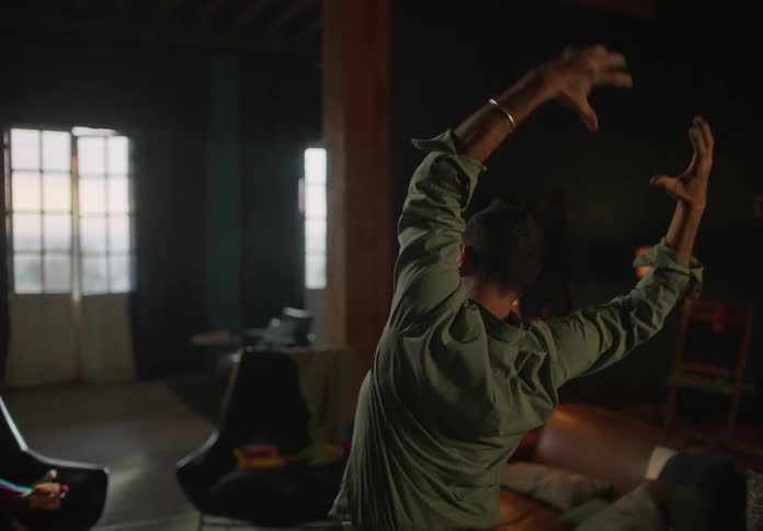 A man is swinging his arms around at home