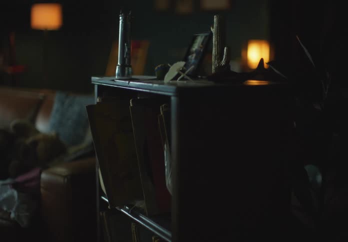 A flashlight rattles while sitting on a side table in a living room
