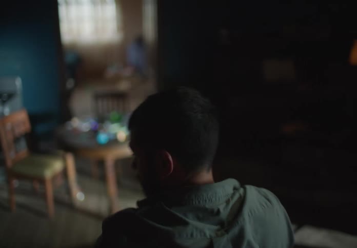 A man standing around in a room looking around