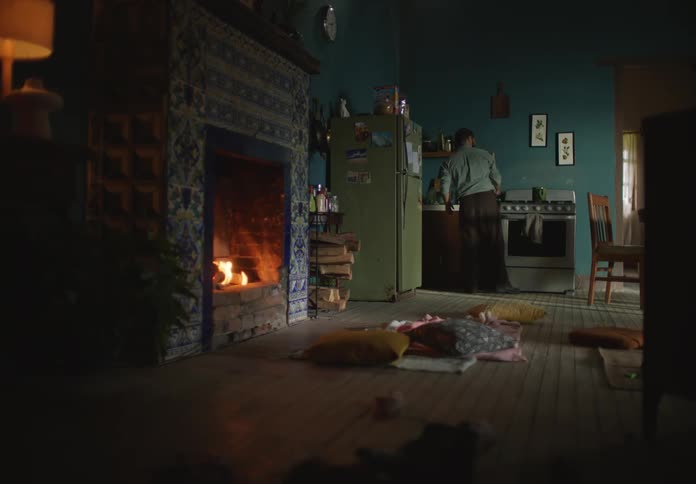 Man cooking on the kitchen at home near the fireplace