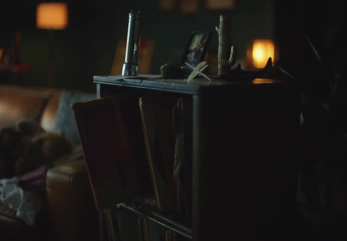 A book shelf trembling and a book falls from the shelf