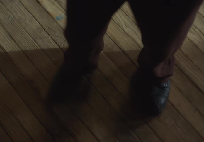 Dancer turns while dancing on wooden floor