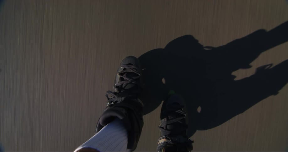 A skater travels down a road on inline skates during the day