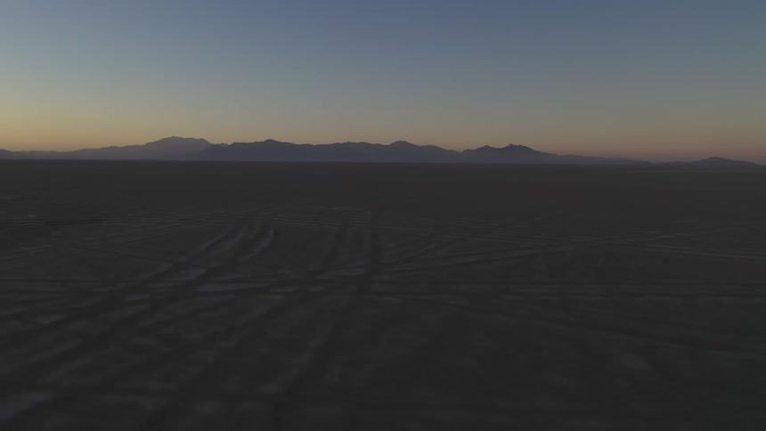 A barren flatland at sunset