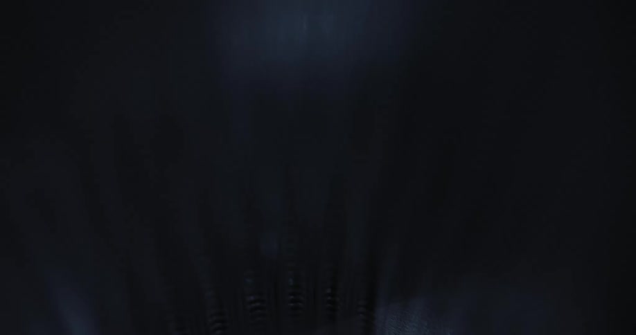 Bright light flows over ribbed textured surface of object