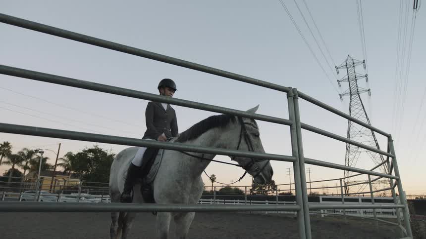A woman is sitting on her horse