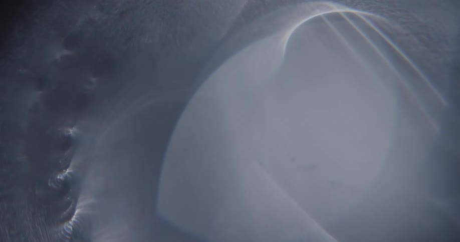 Abstract footage of dust blowing over a circular shape
