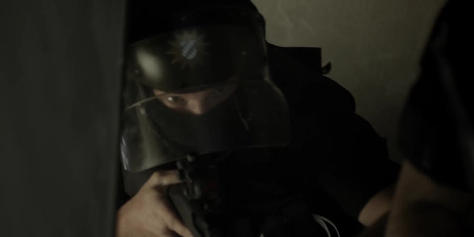 Officers climb up a stairway with weapons