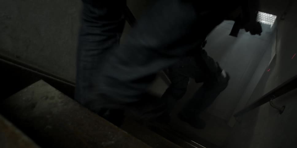 Police go down a stairwell with guns drawn