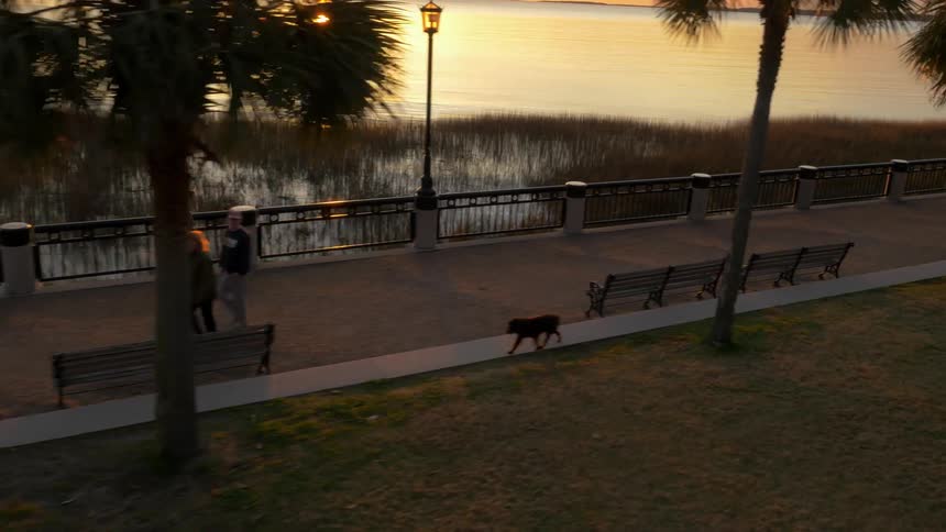 A man jogs on a walkway at sunrise