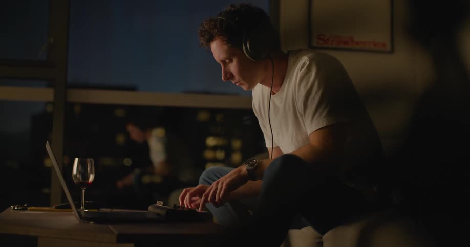 A man sitting in a room using a laptop