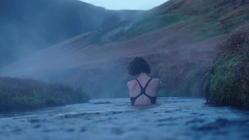 A woman swimming in a stream