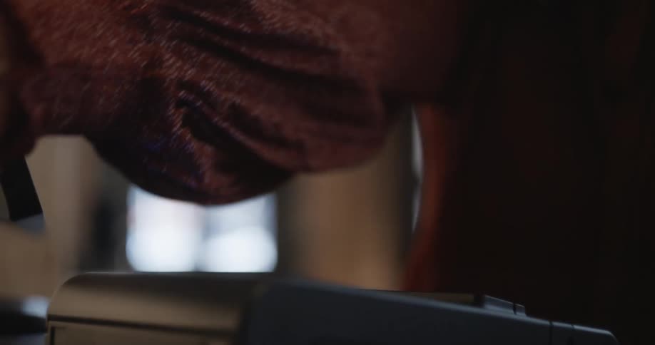 A woman is printing out receipts at her desk