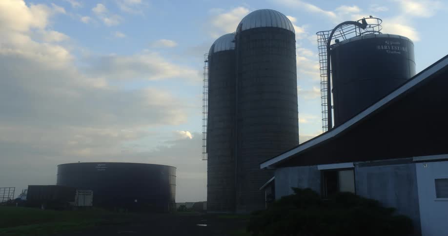 Exterior view of tower tower silos and building at dusk