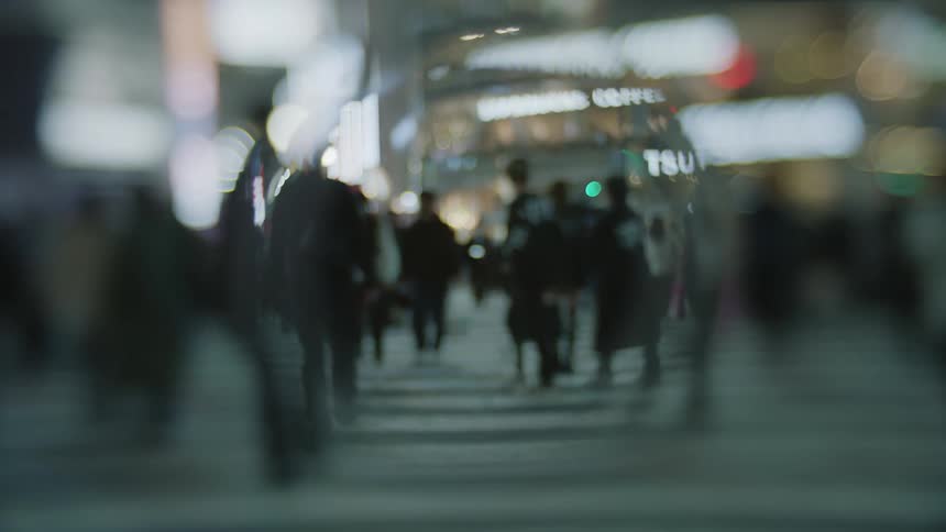 Fisheye lens footage of pedestrians walking on a crosswalk in the city street