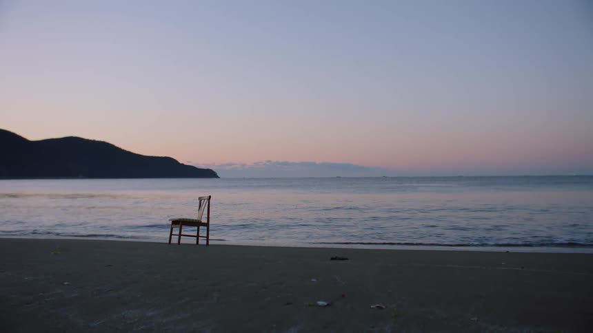 A chair is near the water