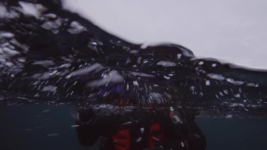 Male scuba diver goes scuba diving on a cloudy day