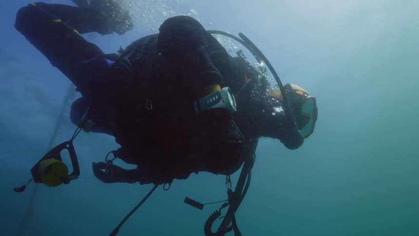 A young man is under the way in the ocean