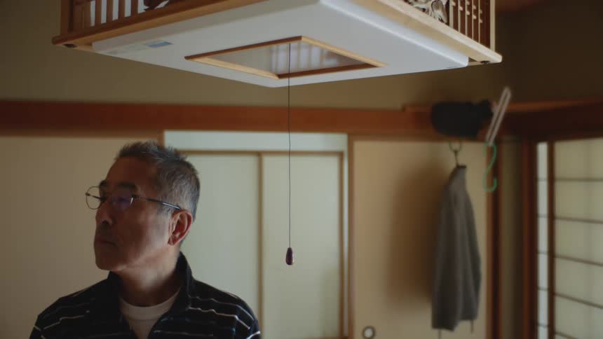 A man is standing in his house by himself