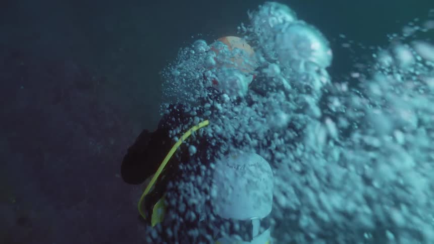A person is scuba diving under the ocean water