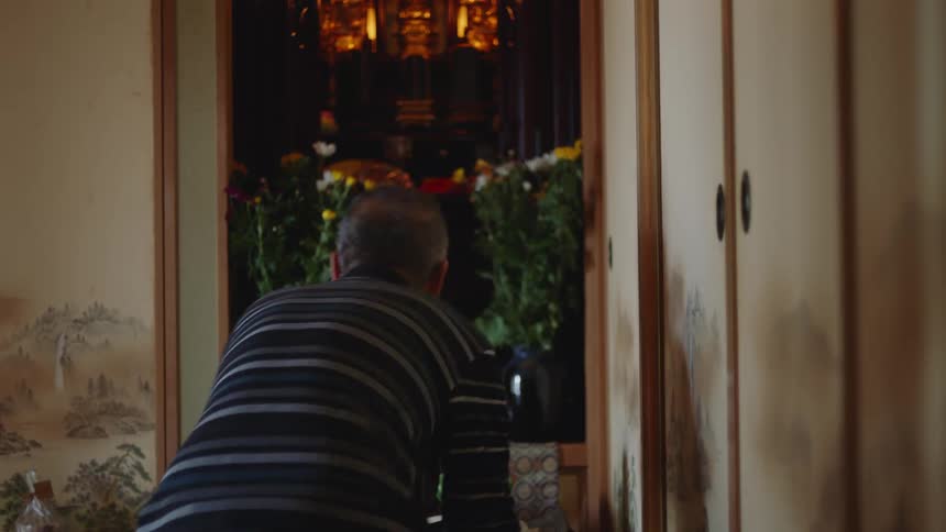 An older man is hanging out inside of his home