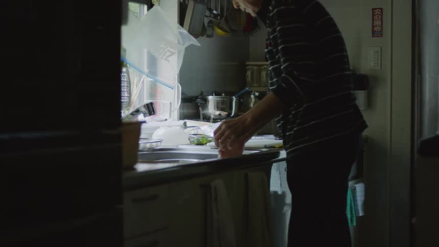 Man washes his hands while working in the kitchen