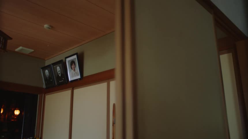 Family portraits hanging on a ledge in a room