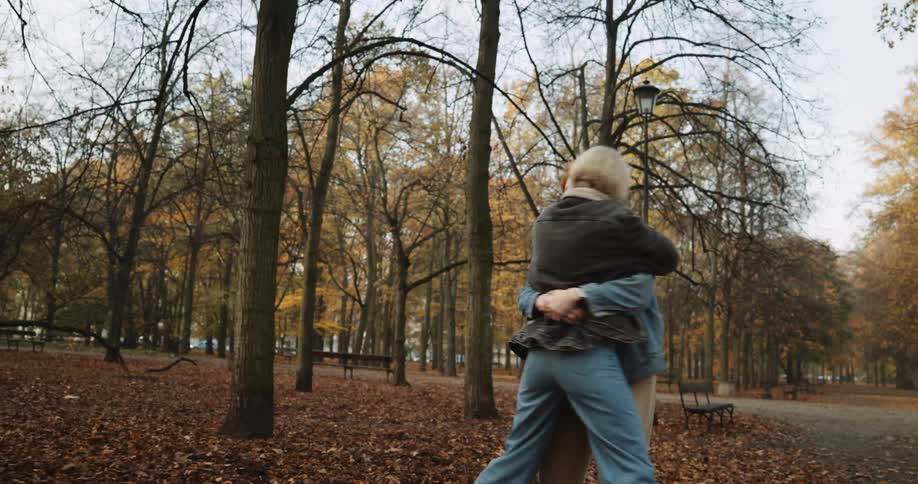 A young couple is being affection towards each other outside
