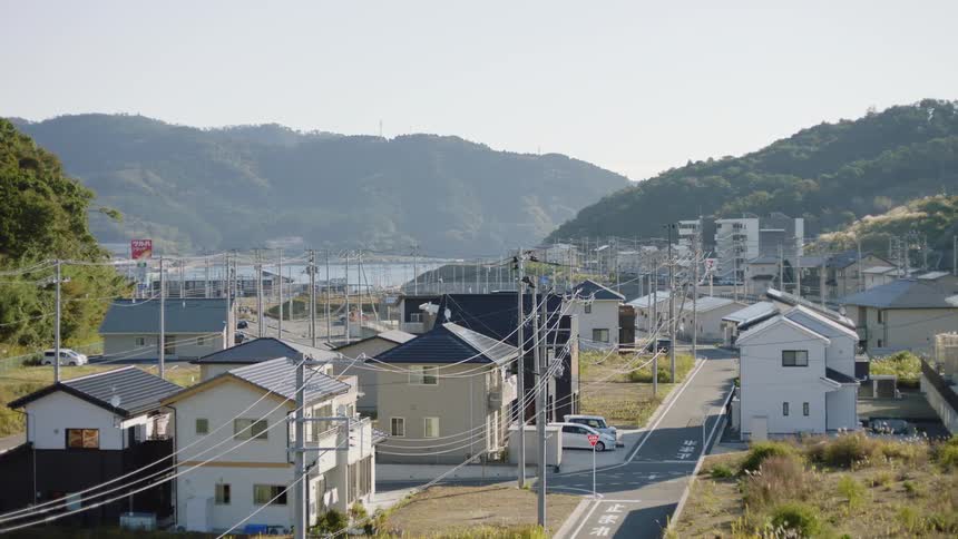 The view is of houses in a small town around the day time