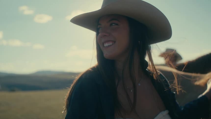 Two people are on a ranch with there horse in the daytime