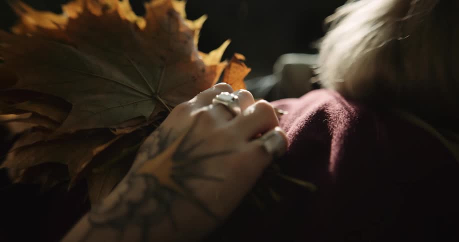 A young couple is laying down outside in the middle of the day