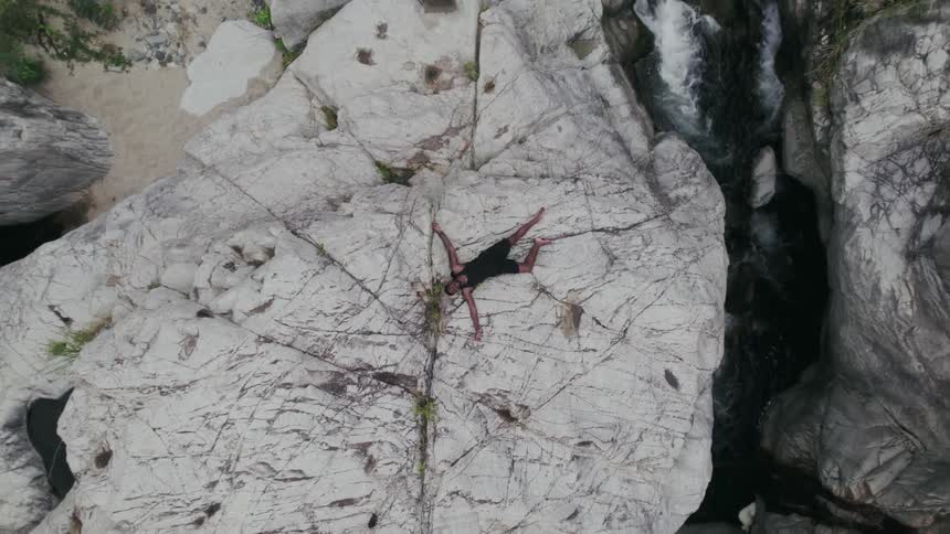 A person is resting on a mountain during spring