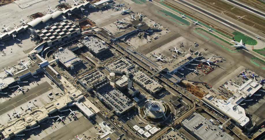 The airport is full of vehicles and planes