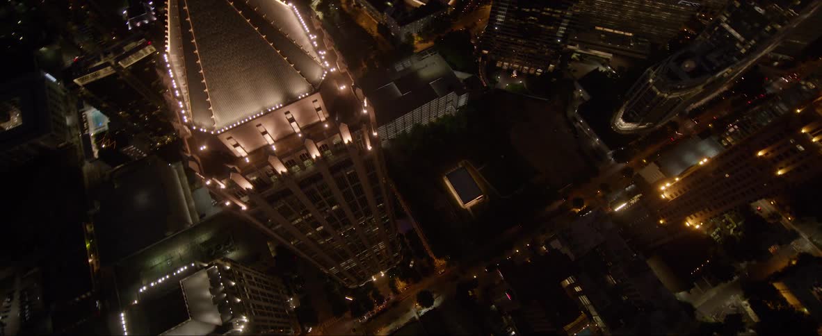 An aerial view of a high rise office building in a city